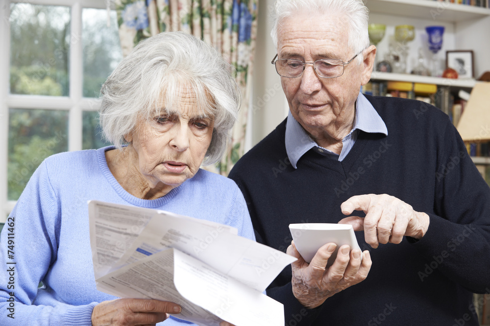 Senior Couple At Home With Bills Worried About Home Finances Senior Couple At Home With Bills Worried About Home Finances