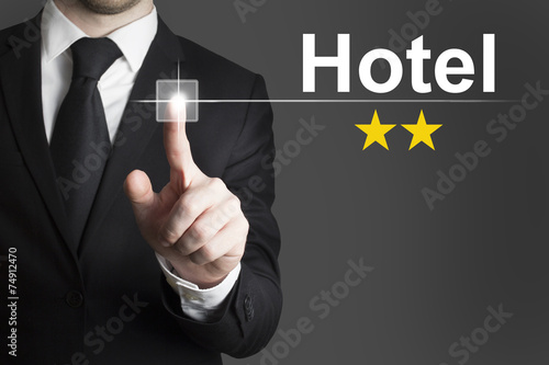 businessman pushing button hotel two stars