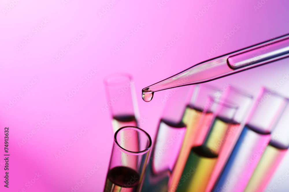 Pipette adding liquid to the one of test-tubes Pipette adding liquid to the one of test-tubes
