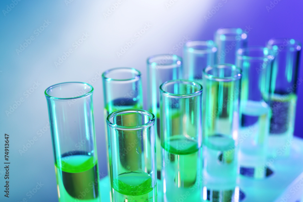 Green fluid in test-tubes on the light background Green fluid in test-tubes on the light background