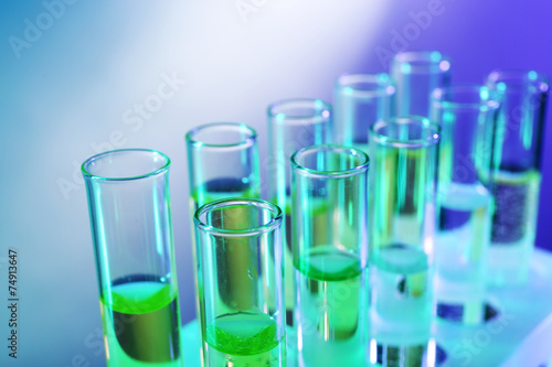 Green fluid in test-tubes on the light background © Africa Studio