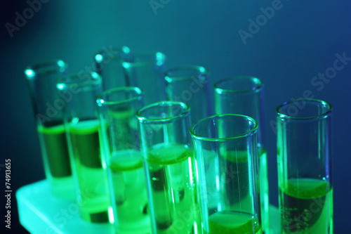 Green fluid in test-tubes on the dark background