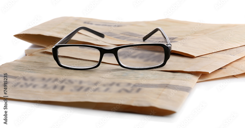 Glasses and newspapers, close-up Glasses and newspapers, close-up