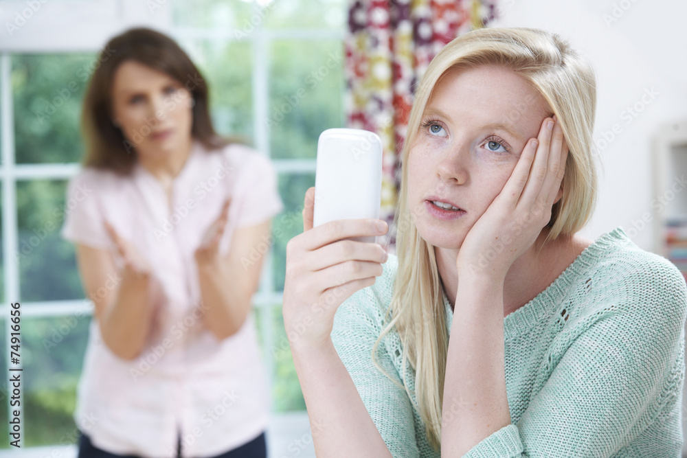 Mother Arguing With Teenage Daughter Over Use Of Mobile Phone Mother Arguing With Teenage Daughter Over Use Of Mobile Phone