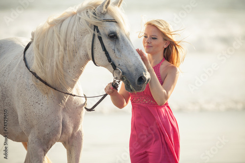Young woman near the horse