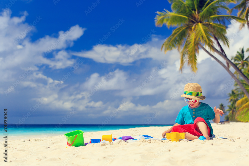 little boy building sand castle on beach little boy building sand castle on beach