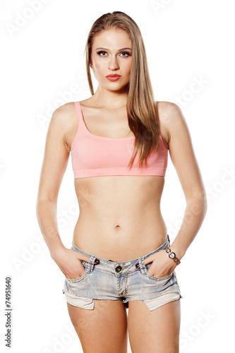 young blonde woman in short jeans posing on a white background