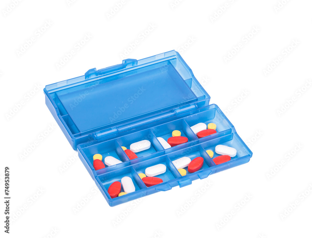 Prescription pills and vitamins in a blue pill box - days of wee Prescription pills and vitamins in a blue pill box - days of wee