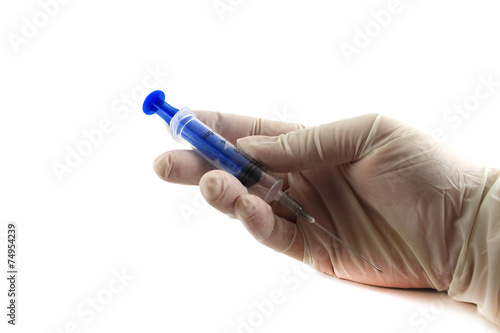 The doctor's hand in glove holding a syringe. Isolated object on