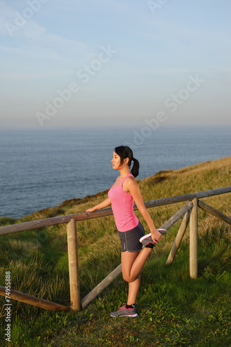 Female athlete stretching after running and exercising © Dirima