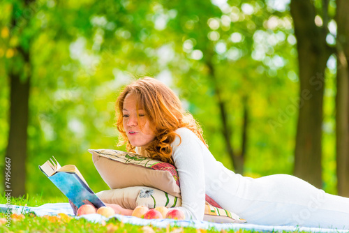 girl in white dress reading a book in the park © kosmos111