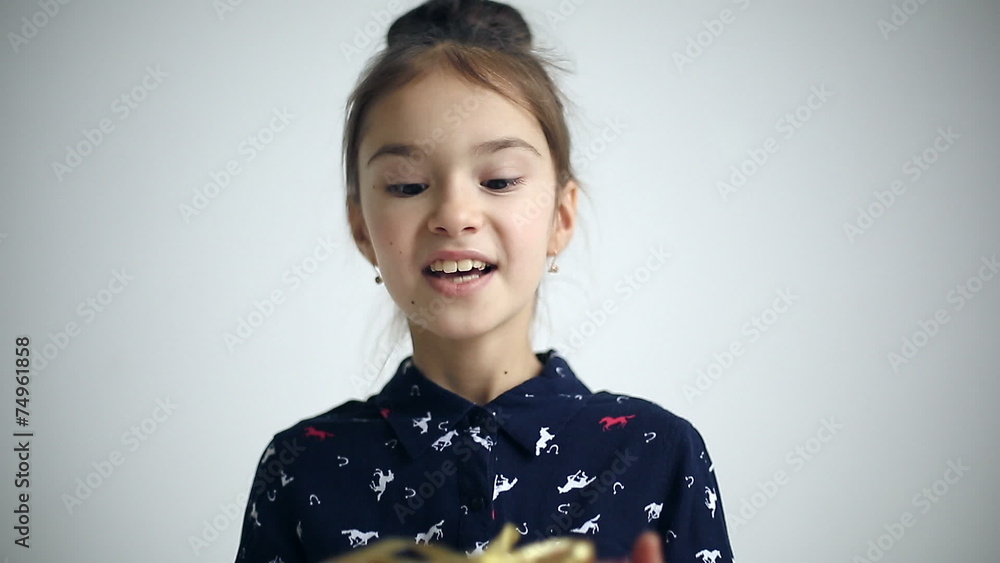 Female child receives a gift surprised and glad. Female child receives a gift surprised and glad.