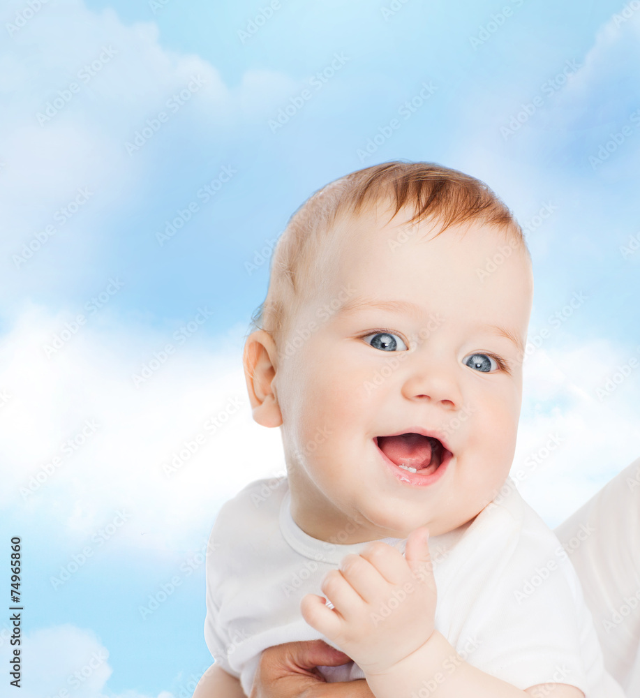 close up of mother holding smiling baby close up of mother holding smiling baby