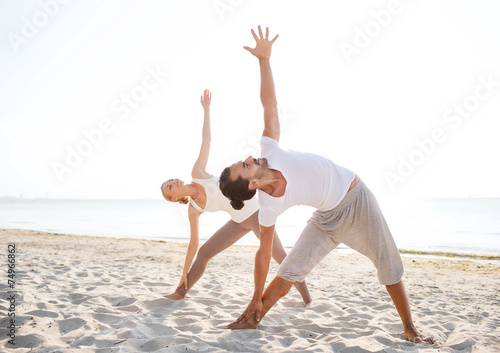 couple making yoga exercises outdoors