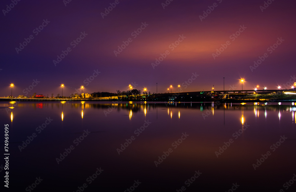 Lights and highways reflecting in the Potomac River at night, se