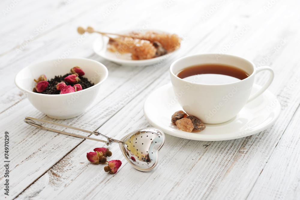 Cup of tea with dry rose buds