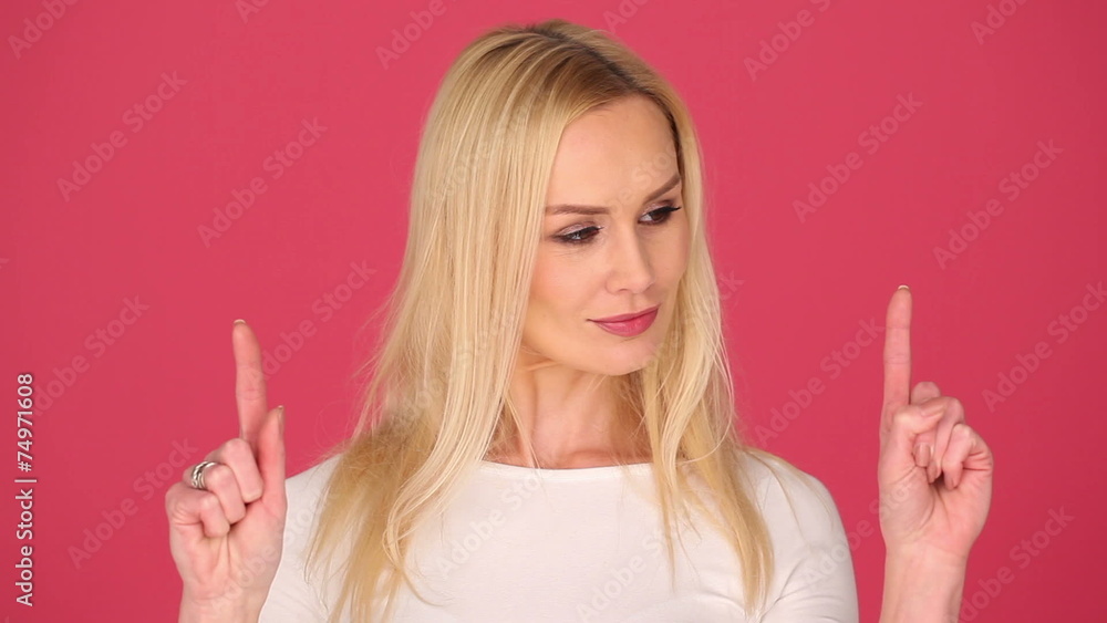 blonde attractive woman on pink background showing space blonde attractive woman on pink background showing space