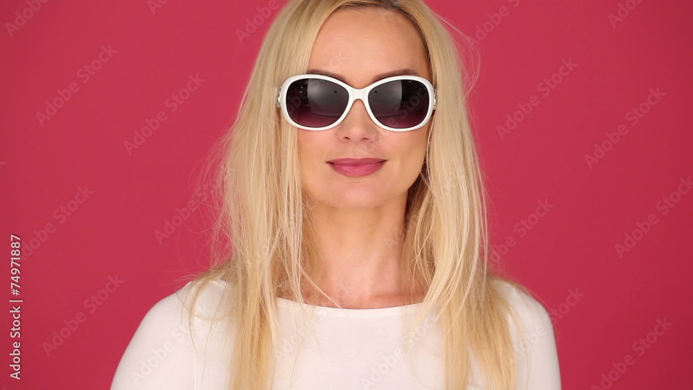 Vivacious young blond woman in trendy sunglasses Vivacious young blond woman in trendy sunglasses