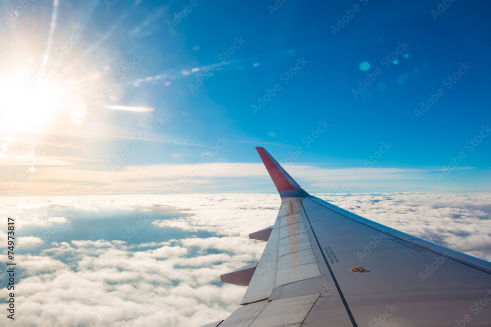 Clouds and sky as seen through window of an aircraft Clouds and sky as seen through window of an aircraft