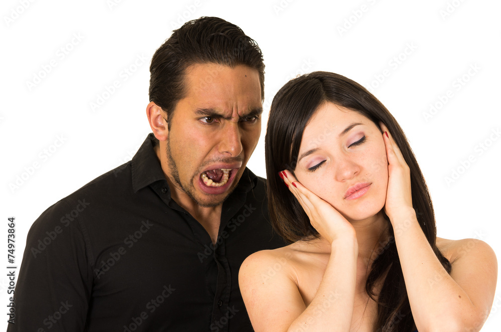 young attractive girl covering ears from angry screaming husband