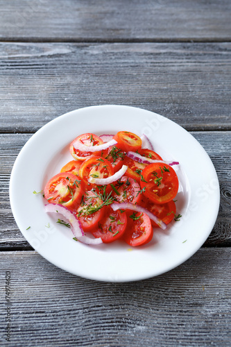 Tomatoes and onions on a white plate