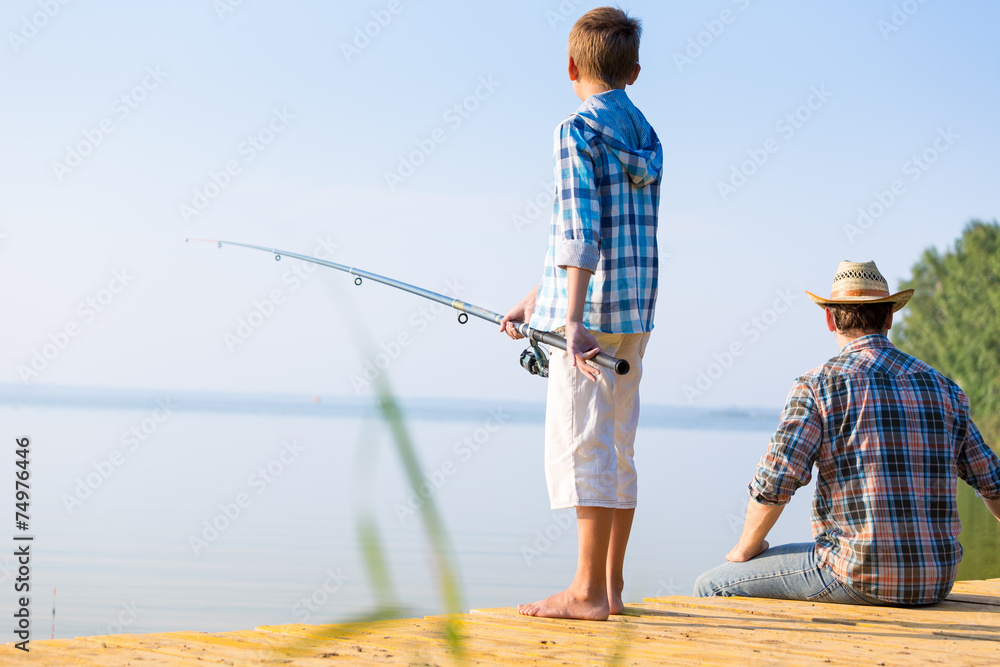boy and his father fishing togethe boy and his father fishing togethe