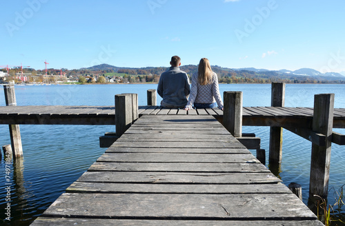 A couple on the wooden jetty at a lake