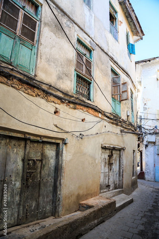 Old dirty buildings in a street in an african city