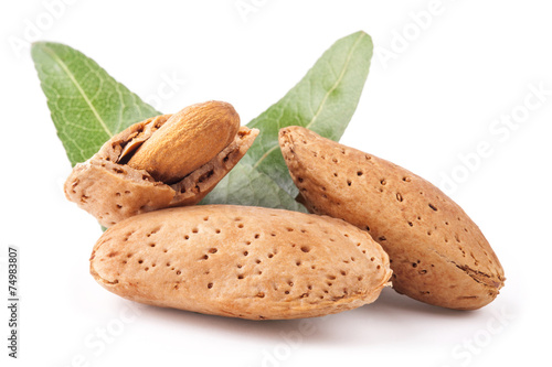 Almond nuts with leaves isolated on white background