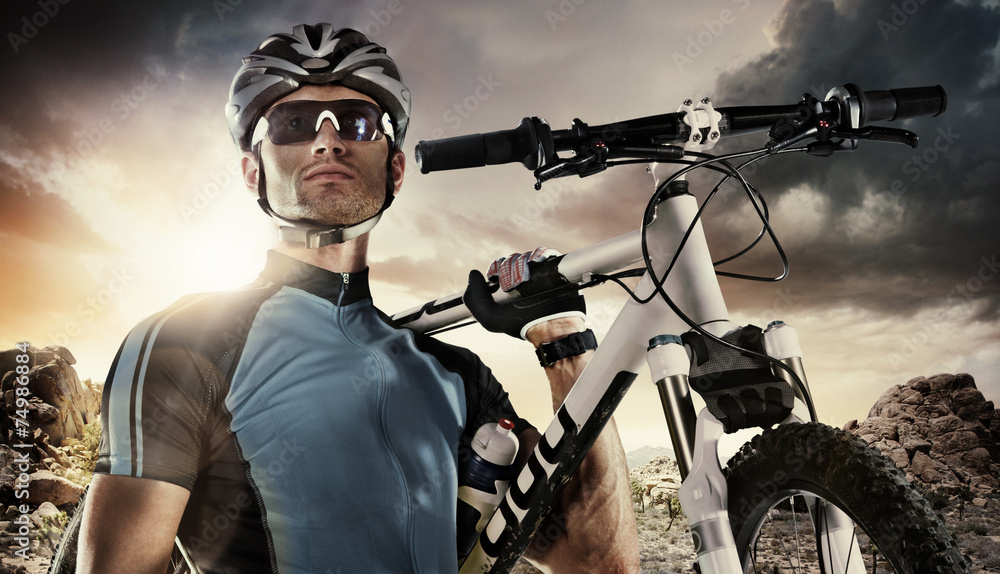 Sport. Cyclist carry a bike on dramatic sky. - obrazy, fototapety, plakaty 