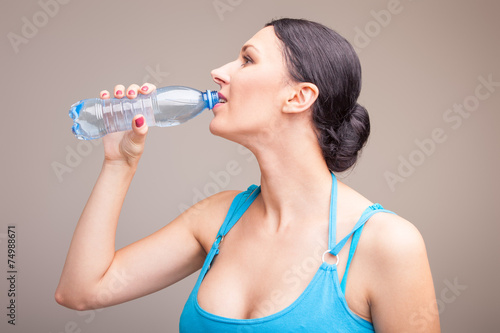 Woman drinking cool water after a workout