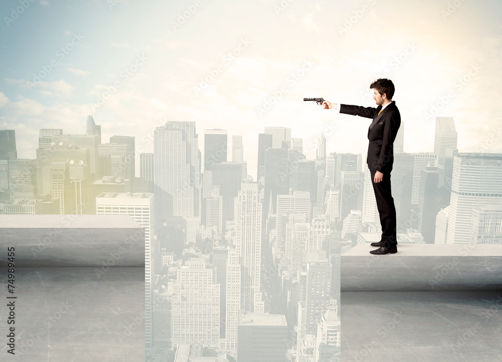Businessman standing on the edge of rooftop Businessman standing on the edge of rooftop
