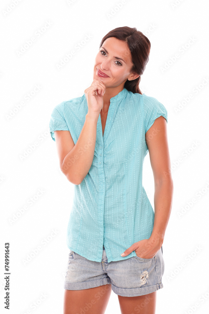 Hispanic holding chin and looking interested Hispanic holding chin and looking interested