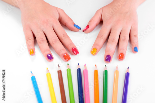 Multicolor female manicure with colored pencils isolated