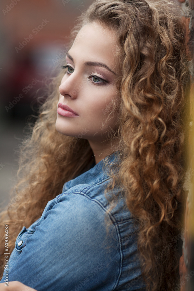 Beautiful young Caucasian girl with curly hair outdoors Stock Photo ...