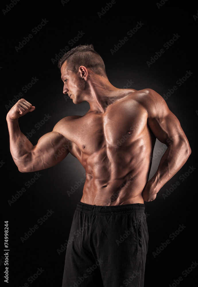 Muscular man on black background