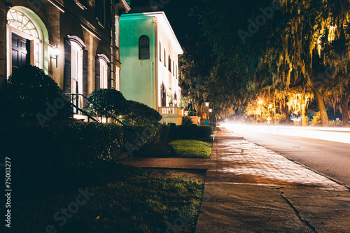 Houses and traffic at night on Drayton Street in Savannah, Georg