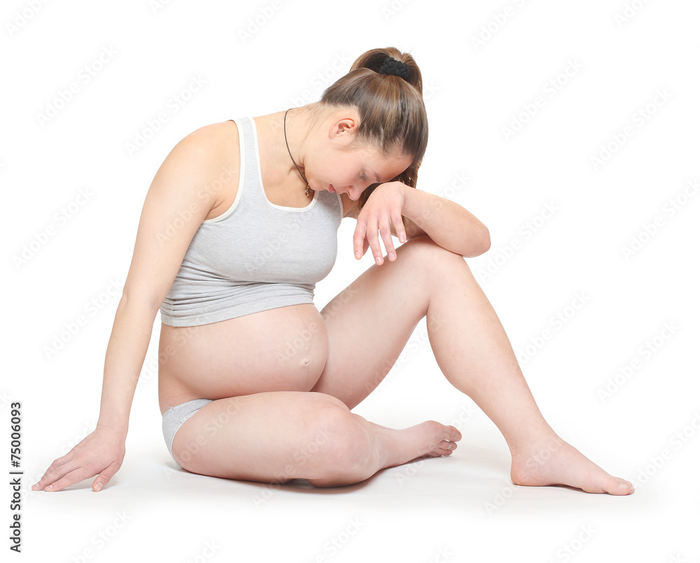 Sad pregnant woman on white background. Prenatal care concept. Sad pregnant woman on white background. Prenatal care concept.