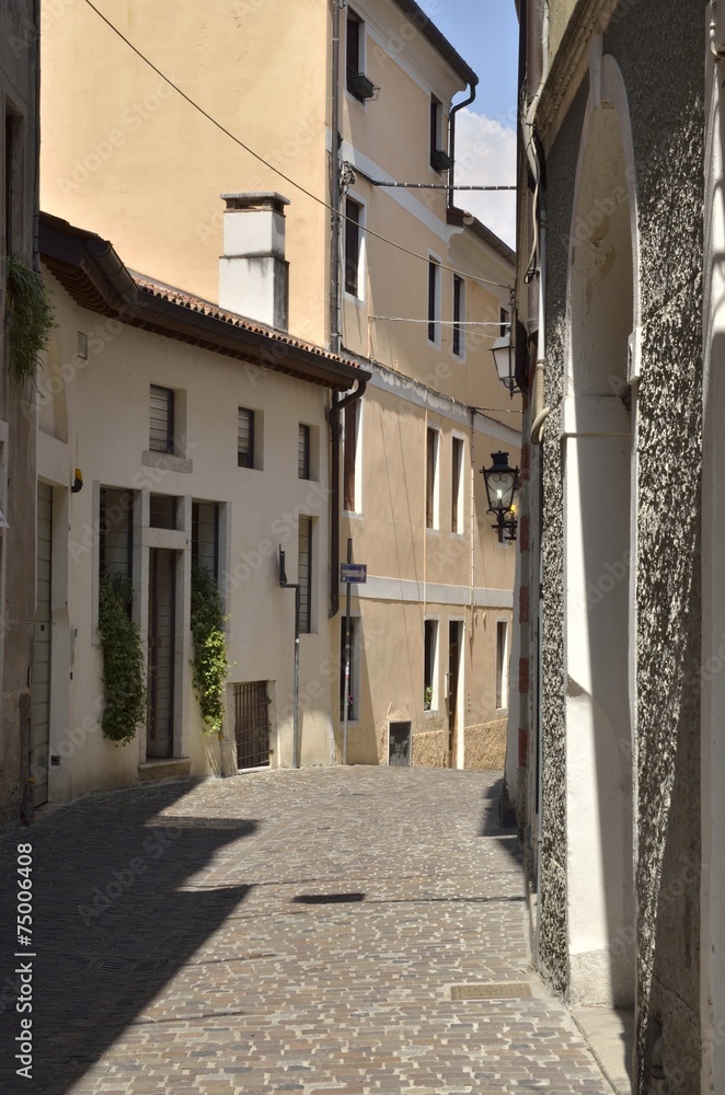 Italian narrow street in the city of Bassano del Grappa, Italy