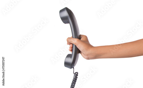 Female hand dialing numbers of desktop telephone 