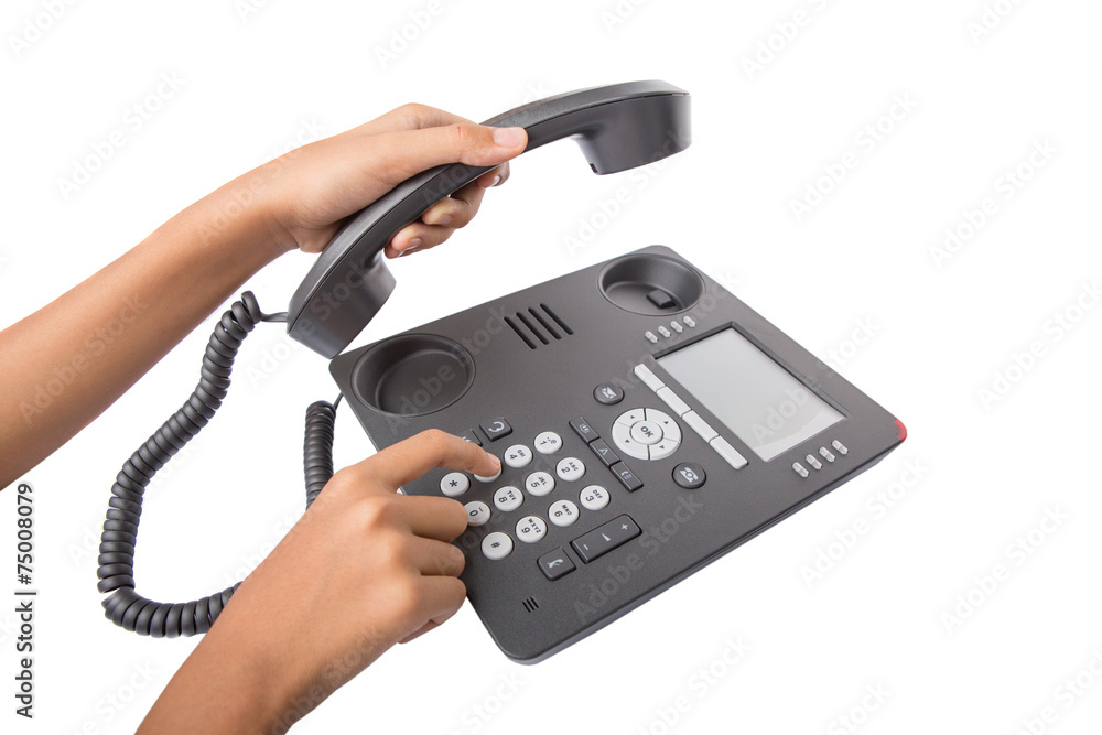 Female hand dialing numbers of desktop telephone Female hand dialing numbers of desktop telephone