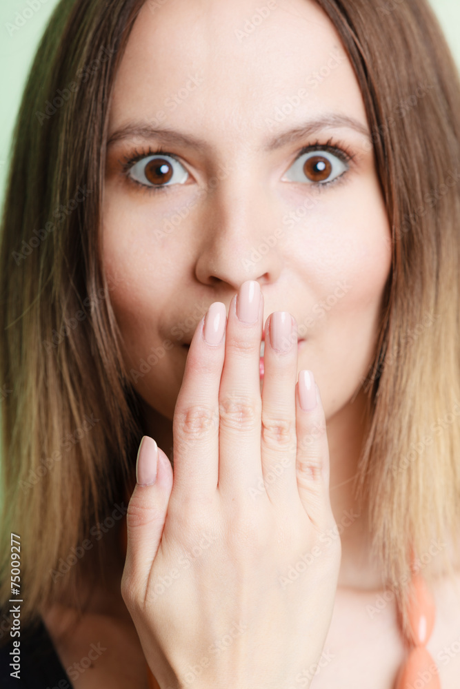 Surprised woman face covering her mouth with hand Surprised woman face covering her mouth with hand