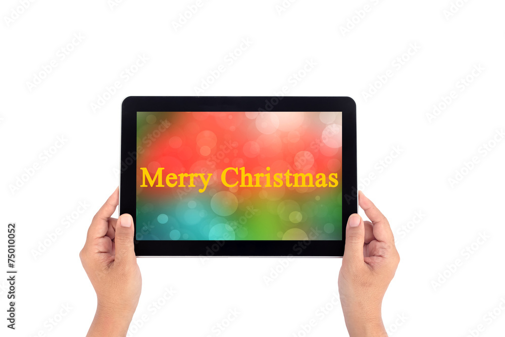 Hand holding tablet with text merry christmas Hand holding tablet with text merry christmas