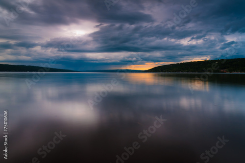Storm clouds move over Lake Cayuga in a long exposure, seen from photo