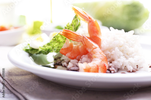 Boiled rice with shrimps served on table, close-up