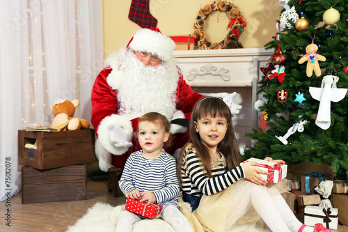 Santa Claus with two little...