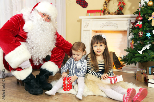 Santa Claus with two little...