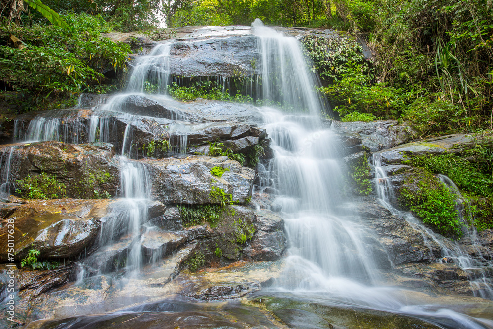 Obraz premium The long exposure image of a beautiful waterfall in the forest