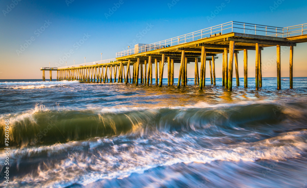A fishing pier and waves in the Atlantic Ocean at sunrise, in Ve