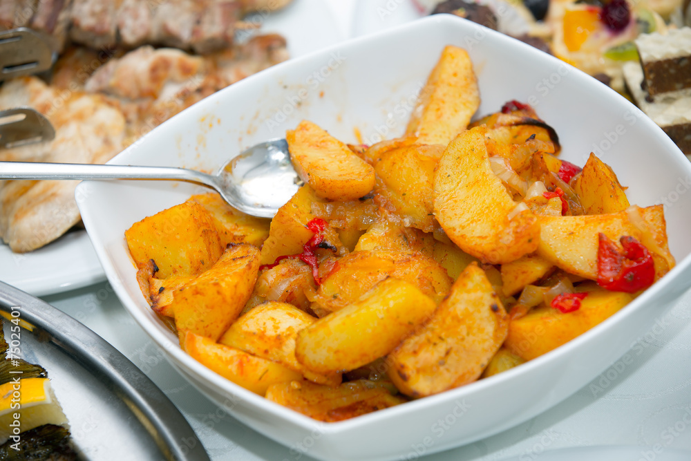 Fried potato wedges on white plate Fried potato wedges on white plate